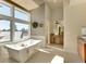 Bright bathroom featuring a modern soaking tub, complemented by a large window offering scenic views at 10177 Rancho Montecito Dr, Parker, CO 80138