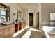 Bright bathroom with double vanities, a soaking tub, and a glass-enclosed shower at 10177 Rancho Montecito Dr, Parker, CO 80138