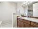 Bathroom with a granite-topped vanity, undermount sink, and a large mirror at 10177 Rancho Montecito Dr, Parker, CO 80138