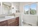 Elegant bathroom with custom vanity, granite countertops, and a bright window overlooking the landscape at 10177 Rancho Montecito Dr, Parker, CO 80138