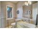 Bright bathroom featuring stone floors, a modern vessel sink, and a decorative window at 10177 Rancho Montecito Dr, Parker, CO 80138