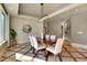 Elegant dining room with a modern chandelier, unique flooring and a stylish round mirror at 10177 Rancho Montecito Dr, Parker, CO 80138