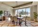 Elegant dining room with modern lighting fixture, large window, and stylish decor at 10177 Rancho Montecito Dr, Parker, CO 80138