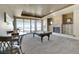 Entertainment room with a pool table, stone fireplace, and sliding glass doors to the outside at 10177 Rancho Montecito Dr, Parker, CO 80138