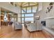 Open-concept living room with hardwood floors, fireplace, and view of the chef's kitchen at 10177 Rancho Montecito Dr, Parker, CO 80138