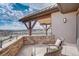 Outdoor patio featuring stone accents, comfortable seating, and scenic views of the surrounding landscape at 10177 Rancho Montecito Dr, Parker, CO 80138