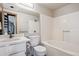 Bright bathroom with a tub and shower combination, white vanity, and updated fixtures at 5250 S Huron Way # 5-308, Littleton, CO 80120