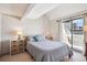 Bedroom with neutral tones, sliding glass door to a balcony and bedside tables with storage at 5250 S Huron Way # 5-308, Littleton, CO 80120