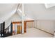Bright bonus room with vaulted ceilings, skylight and staircase featuring sleek metal railing at 5250 S Huron Way # 5-308, Littleton, CO 80120