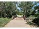 Scenic wooden bridge surrounded by lush trees and greenery, offering a peaceful pathway at 5250 S Huron Way # 5-308, Littleton, CO 80120