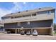 Exterior of the condo building highlighting the assigned covered parking and building design at 5250 S Huron Way # 5-308, Littleton, CO 80120