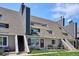 Multi-story condo building displaying stairs, patio area, and a well-maintained lawn at 5250 S Huron Way # 5-308, Littleton, CO 80120