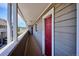 Exterior view of building with red doors and views of a grassy area and the mountains at 5250 S Huron Way # 5-308, Littleton, CO 80120