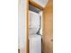 Convenient laundry closet featuring a stacked washer and dryer unit with wood frame at 5250 S Huron Way # 5-308, Littleton, CO 80120