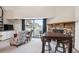Living area featuring a fireplace, sliding glass door to a balcony, and floral armchairs at 5250 S Huron Way # 5-308, Littleton, CO 80120