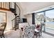 Open living area features a spiral staircase, sliding glass door to a balcony and seating area at 5250 S Huron Way # 5-308, Littleton, CO 80120
