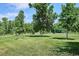 Expansive green park with mature trees and a community gathering pavilion in the distance, ideal for outdoor activities at 5250 S Huron Way # 5-308, Littleton, CO 80120