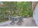 Spacious wooden deck with outdoor dining set, perfect for entertaining and enjoying nature at 9670 W 69Th Ave, Arvada, CO 80004
