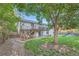 Back exterior with a spacious deck, stone staircase, and a well-maintained lawn at 9670 W 69Th Ave, Arvada, CO 80004