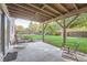 Covered back patio with seating area overlooking the lush backyard and playset at 9670 W 69Th Ave, Arvada, CO 80004
