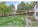 Large backyard features a lush lawn, mature trees, and a fun playset for  at 9670 W 69Th Ave, Arvada, CO 80004