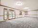 Spacious carpeted basement featuring a sliding door exit for easy access to the outside at 9670 W 69Th Ave, Arvada, CO 80004