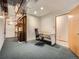 The basement includes shelving, carpet, a chair, and a desk at 9670 W 69Th Ave, Arvada, CO 80004
