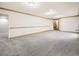 Open basement featuring carpet, trim, and access to other rooms at 9670 W 69Th Ave, Arvada, CO 80004