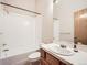Well-lit bathroom with a shower-tub combination and a vanity with storage at 9670 W 69Th Ave, Arvada, CO 80004