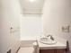 The white bathroom includes a tub, shower, and a classic sink and vanity at 9670 W 69Th Ave, Arvada, CO 80004
