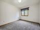 This bedroom offers neutral carpeting, a window, and simple, clean walls at 9670 W 69Th Ave, Arvada, CO 80004