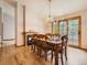 Warm dining area featuring a fireplace, hardwood floors, and large sliding doors to the outside at 9670 W 69Th Ave, Arvada, CO 80004
