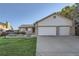 Charming single-story home with a well-manicured lawn and a large three-car garage at 9670 W 69Th Ave, Arvada, CO 80004