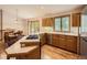 Bright kitchen featuring wood cabinets, stainless steel appliances, hardwood floors, and eat-in counter at 9670 W 69Th Ave, Arvada, CO 80004