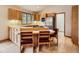 Inviting kitchen with stainless refrigerator, modern appliances, hardwood floors, and a breakfast bar at 9670 W 69Th Ave, Arvada, CO 80004