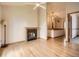 Cozy living room featuring a fireplace, hardwood floors, and an open floor plan at 9670 W 69Th Ave, Arvada, CO 80004