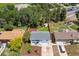 Aerial view of landscaped backyard featuring shed, wood fence, mature trees, and pristine lawn at 13051 W Jewell Cir, Lakewood, CO 80228