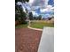 Backyard with manicured lawn, mulch beds, shed, concrete patio, and privacy fence, creating a serene outdoor space at 13051 W Jewell Cir, Lakewood, CO 80228
