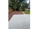 Backyard featuring a concrete patio, lush lawn, mulch beds, mature trees, storage shed, and wood fence at 13051 W Jewell Cir, Lakewood, CO 80228