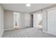 Spacious carpeted basement with neutral walls, white trim, and access to a downstairs powder room and stairs at 13051 W Jewell Cir, Lakewood, CO 80228