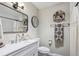 Stylish bathroom featuring modern sink, decorative shelving, and elegant mirror at 13051 W Jewell Cir, Lakewood, CO 80228