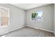 Inviting bedroom with plush carpet and bright windows offering natural light at 13051 W Jewell Cir, Lakewood, CO 80228