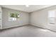 Bright bedroom with new carpet and windows that offer a pleasant outdoor view at 13051 W Jewell Cir, Lakewood, CO 80228