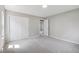 Neutral bedroom featuring plush carpet, large closet with bright light, freshly painted walls at 13051 W Jewell Cir, Lakewood, CO 80228