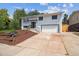 Charming two-story home with white exterior, landscaped yard, and attached two-car garage at 13051 W Jewell Cir, Lakewood, CO 80228