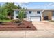 Charming two-story home with white exterior, landscaped yard, and attached two-car garage at 13051 W Jewell Cir, Lakewood, CO 80228