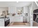 Bright kitchen featuring quartz counters, stainless appliances, and stylish white cabinetry at 13051 W Jewell Cir, Lakewood, CO 80228