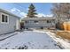 Fenced backyard with detached shop and snow at 3720 S Hazel Ct, Englewood, CO 80110