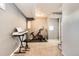 Finished basement with exercise equipment and a keyboard at 3720 S Hazel Ct, Englewood, CO 80110