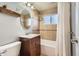 Clean bathroom with a tub, shower, and updated vanity at 3720 S Hazel Ct, Englewood, CO 80110